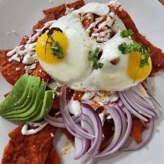 Mari Vees chilaquiles topped with eggs, avocado and crema